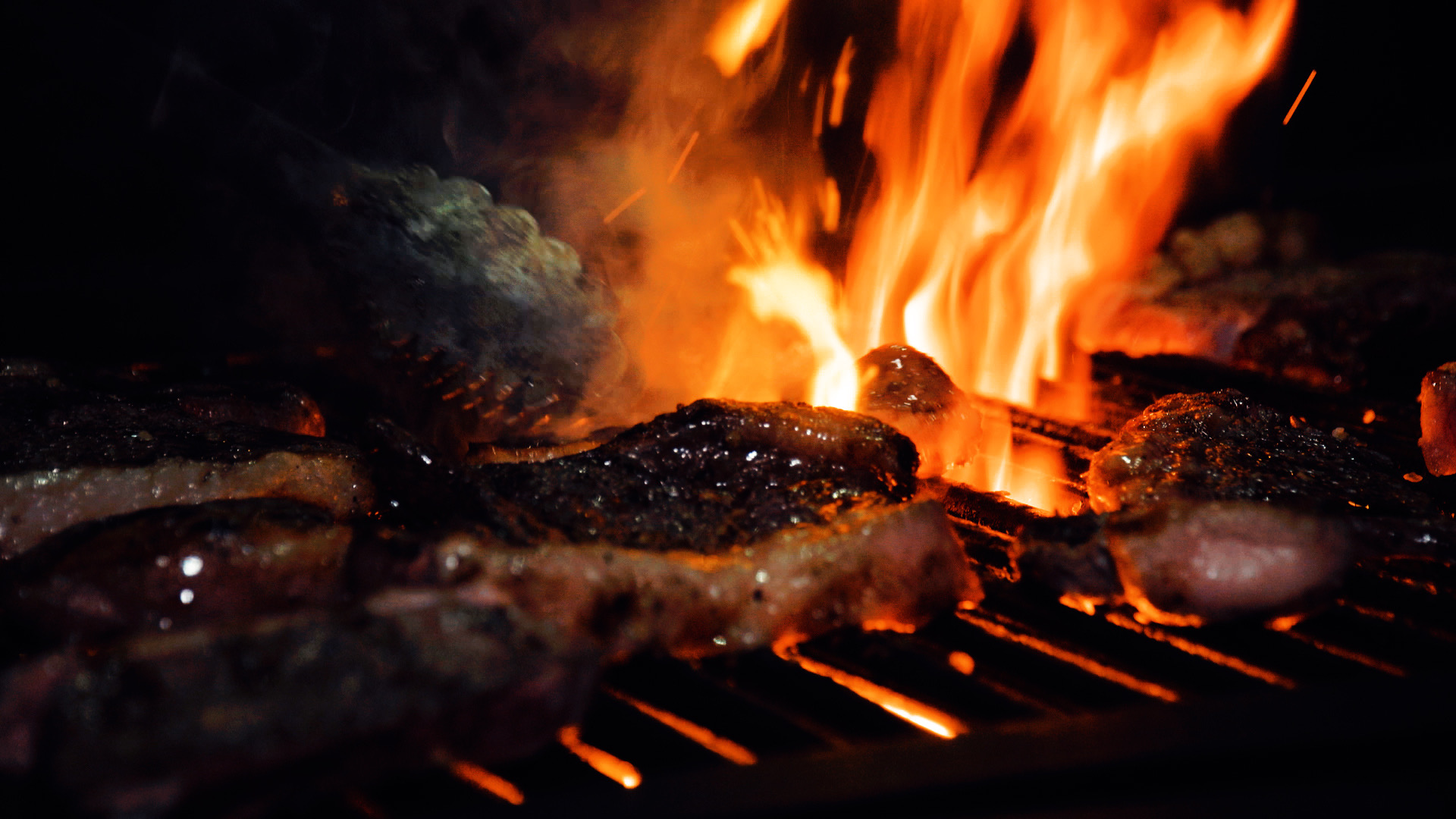 Brazilian BBQ picanha on grill with dramatic flames